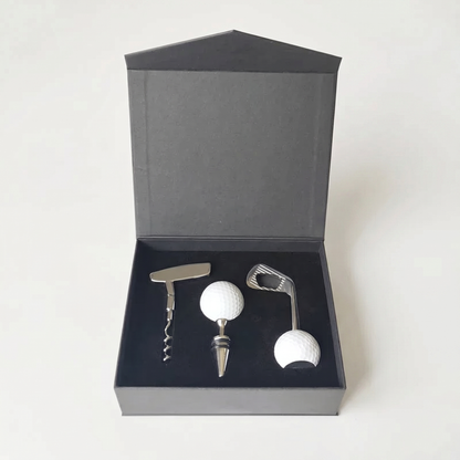Golf-themed wine opener and bottle stopper set in a black box on a white background