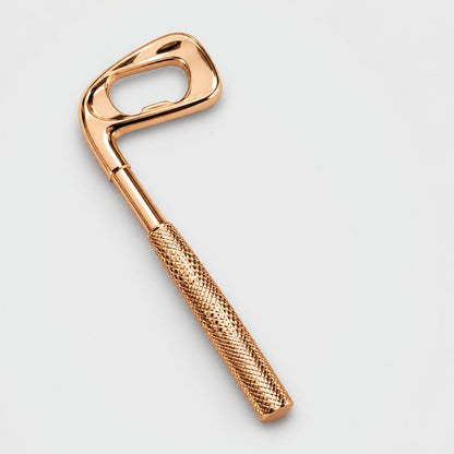 Gold golf club shaped bottle opener on a plain light background