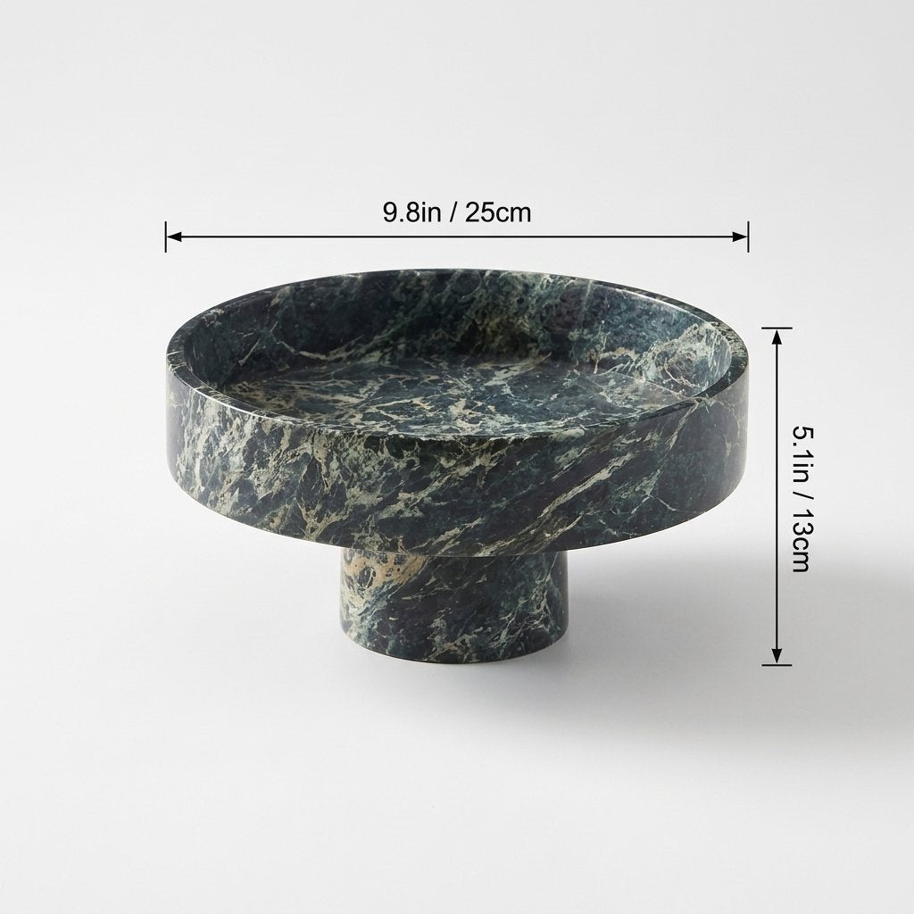 Empty green marble pedestal fruit bowl on a plain background with measurements marked: width 9.8 inches, height 5.1 inches