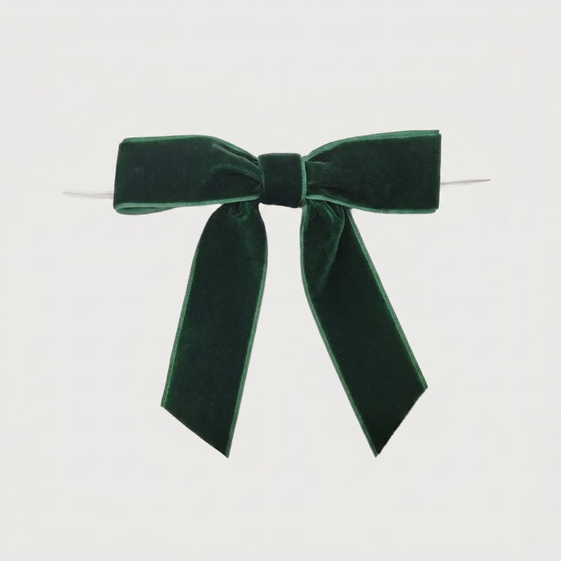 Green velvet bow on white background