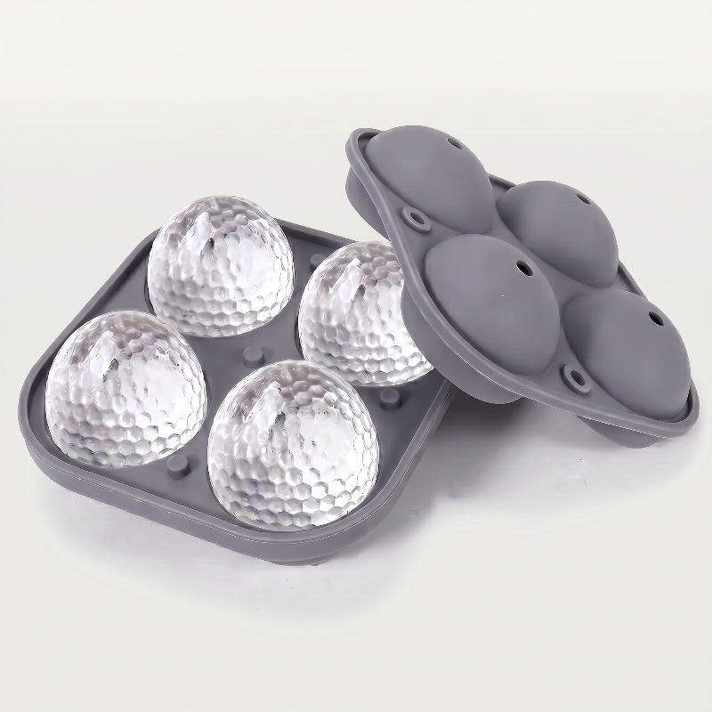 Grey golf ball ice mold tray on white background with molded ice balls