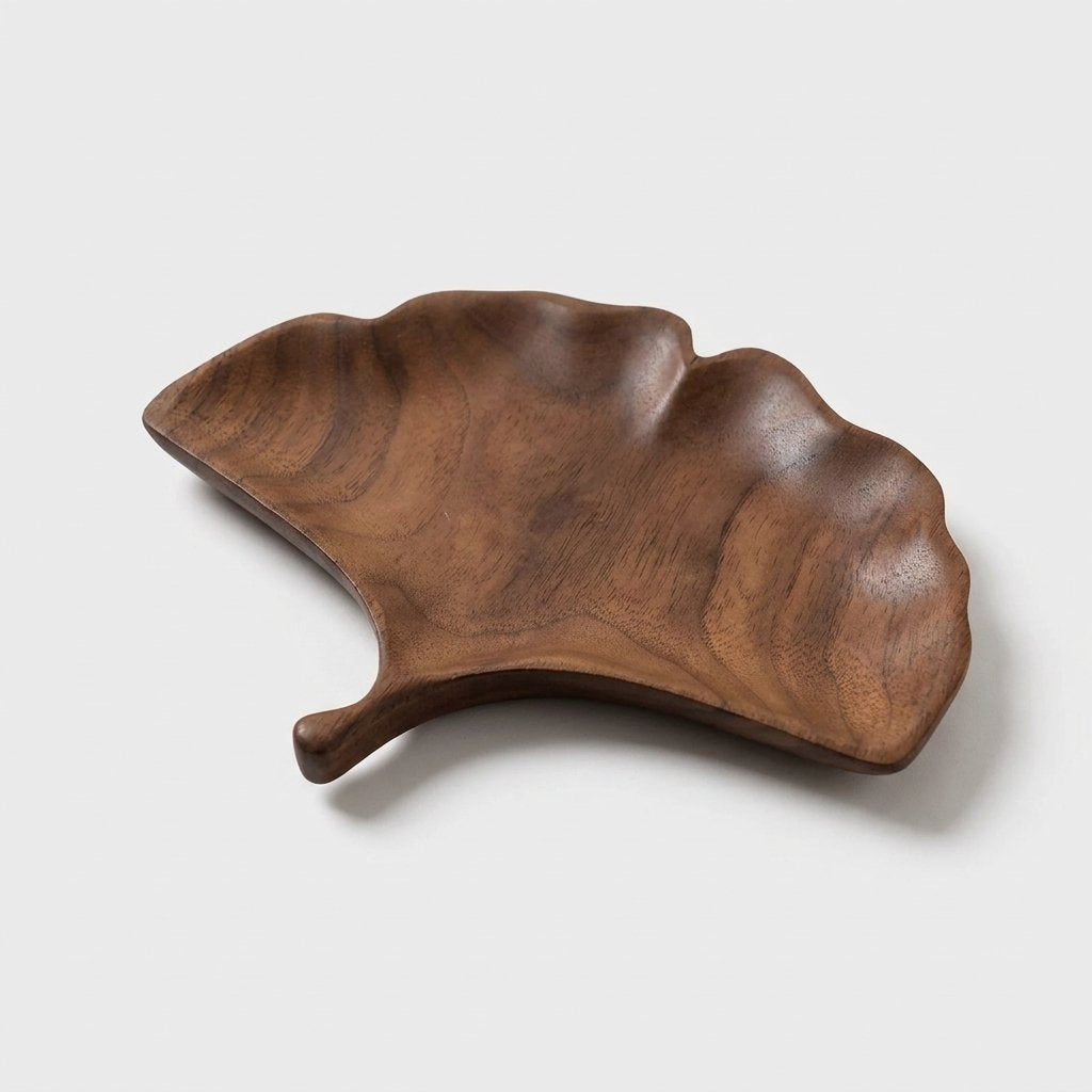 Ginkgo fan-shaped walnut leaf tray with a short curved stem on a light background