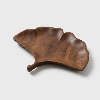 Ginkgo fan-shaped walnut leaf tray with a short curved stem on a light background