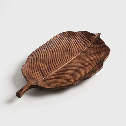 Hazel walnut leaf tray with a serrated edge and fine carved veins on a light background