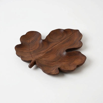 Maple-style walnut leaf tray with rounded lobes on a light background