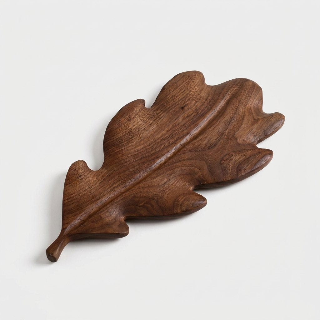 Large runcinate walnut leaf tray with deep lobes on a light background