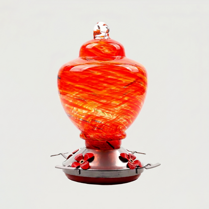 Red handblown glass hummingbird feeder on white background