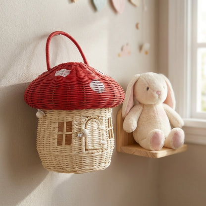 Red mushroom basket on a wall hook beside a plush bunny in a nursery