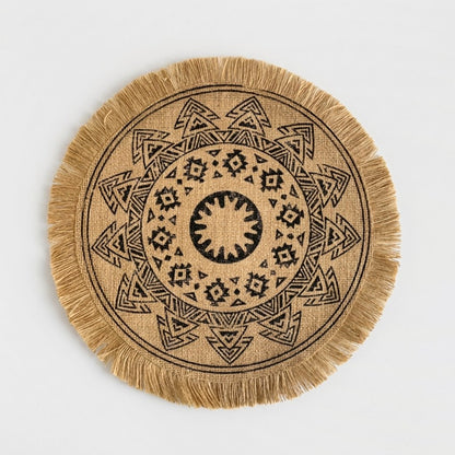 Round handwoven natural jute placemat with a black triangle pattern and jute fringe edge on a light grey background