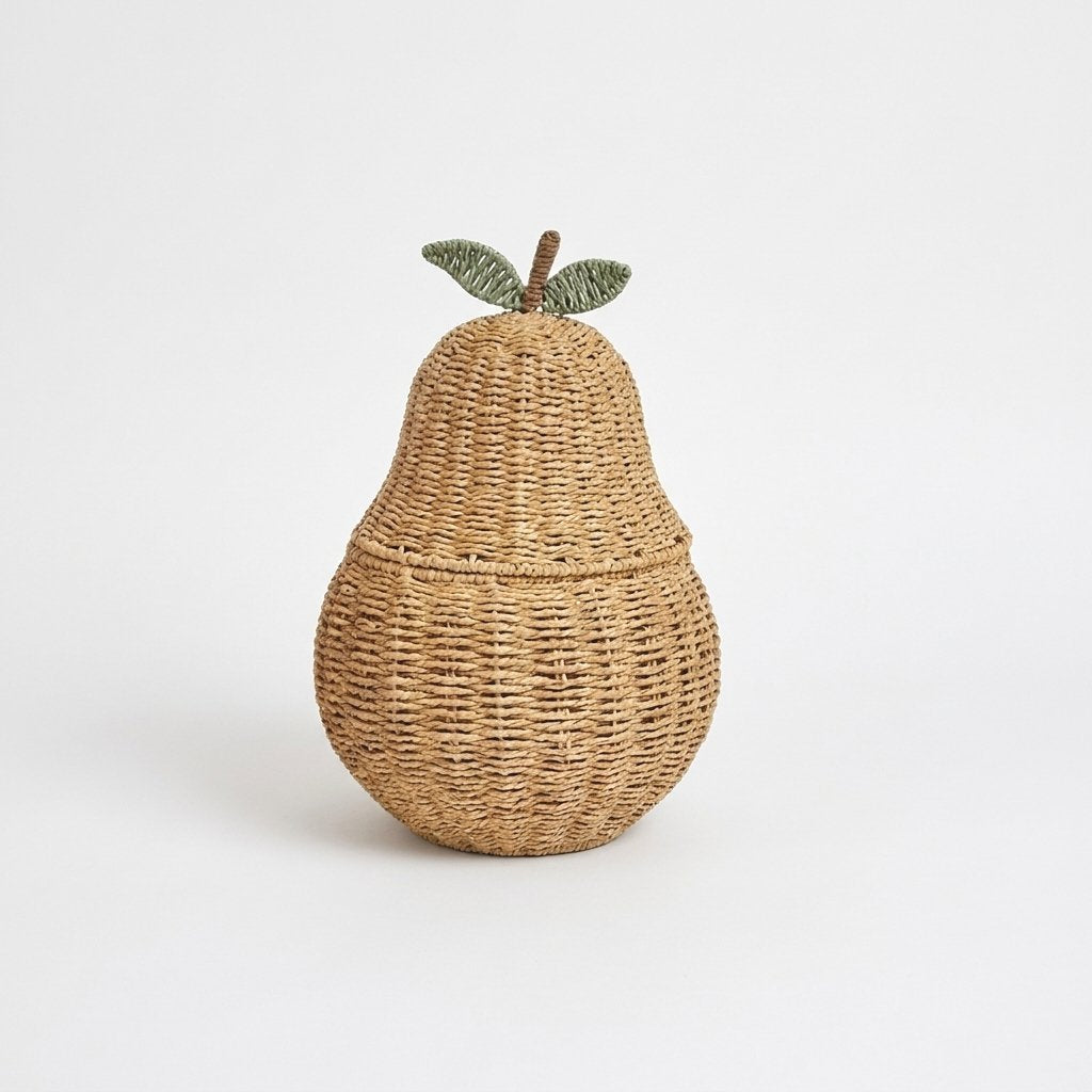 Pear-shaped woven rattan lidded basket with a brown stem and two green leaves on a light background