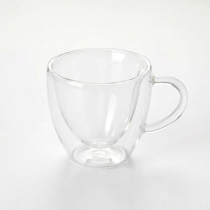 Large empty heart-shaped glass mug on a plain white background