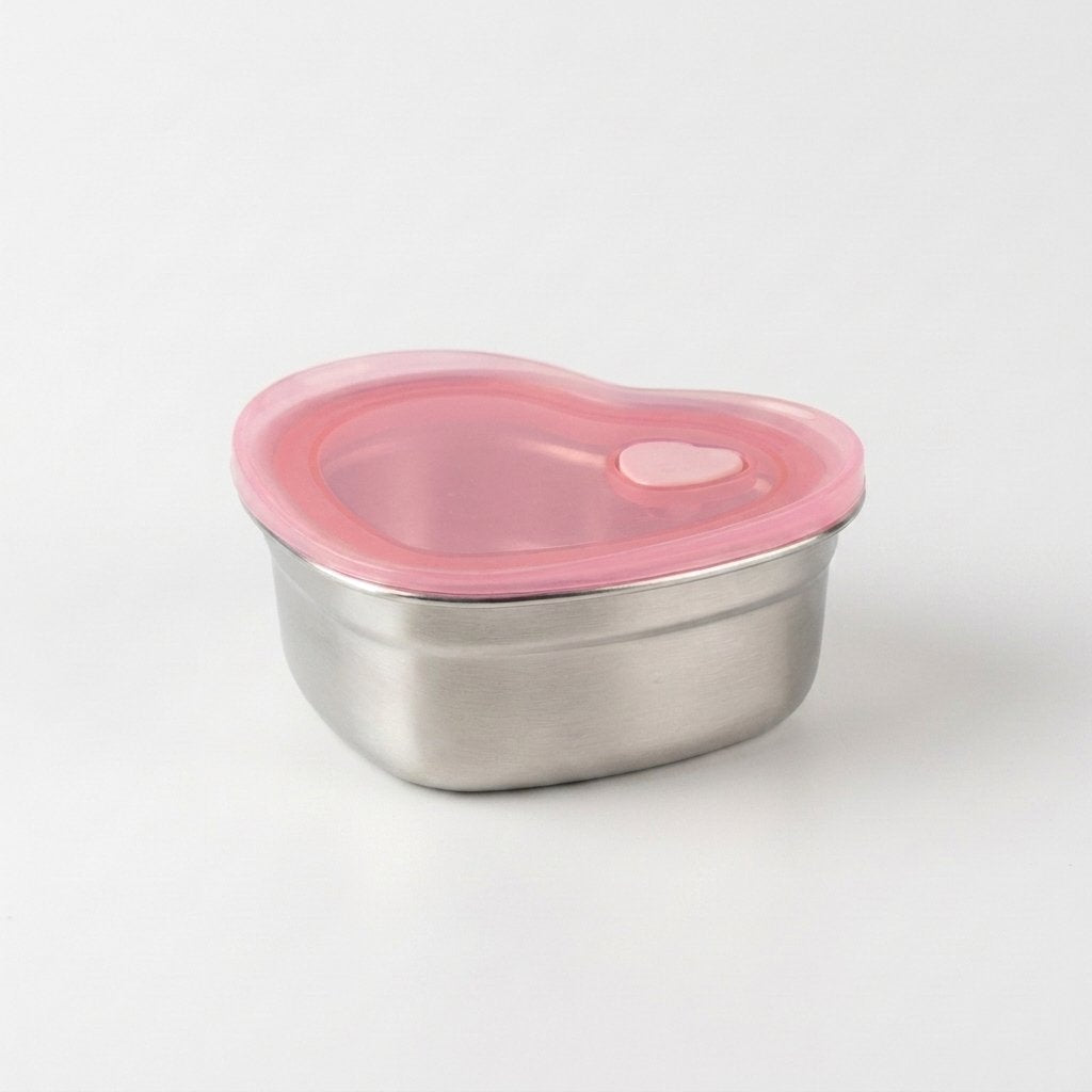 Heart-Shaped Stainless Steel Food Container with pink silicone lid on a plain background