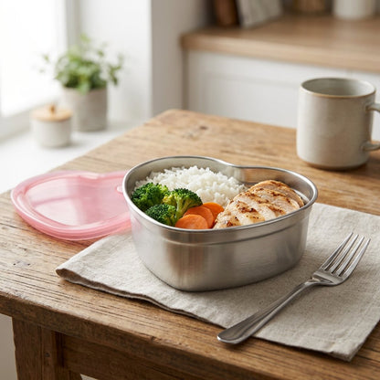 Heart-Shaped Stainless Steel Food Container filled with chicken, rice, and vegetables on a wood table with a fork