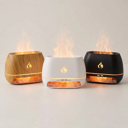 Three flame-shaped diffusers in wooden, white, and black on a light background