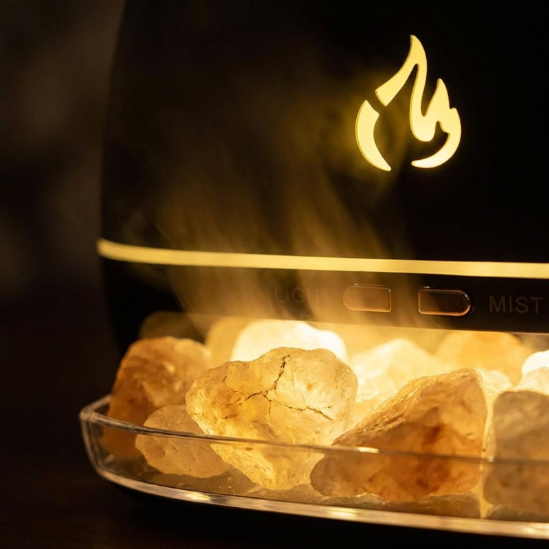 Fireplace with rocks and flames, featuring a brand logo in the background.