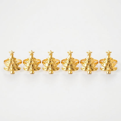 Six gold Christmas tree napkin rings in a row on a white background