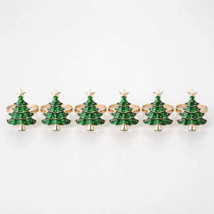 Six green enamel Christmas tree napkin rings with gold trim in a row on a white background