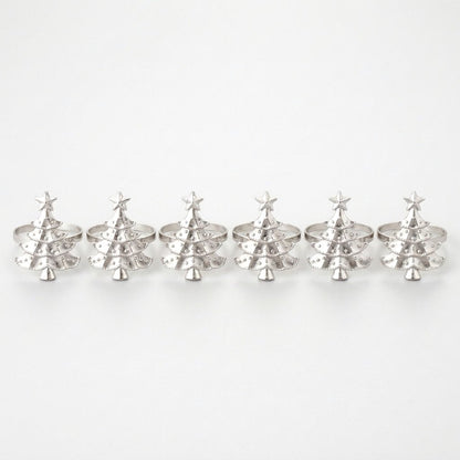 Six silver Christmas tree napkin rings in a row on a white background