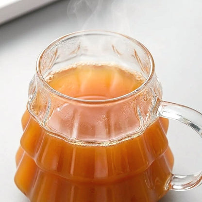 Close-up of the tree-shaped glass's ridged rim filled with steaming cider