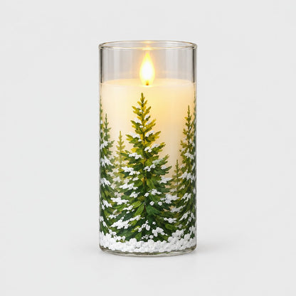 Large flameless candle printed with a snowy pine tree and a glowing flame on a plain light background