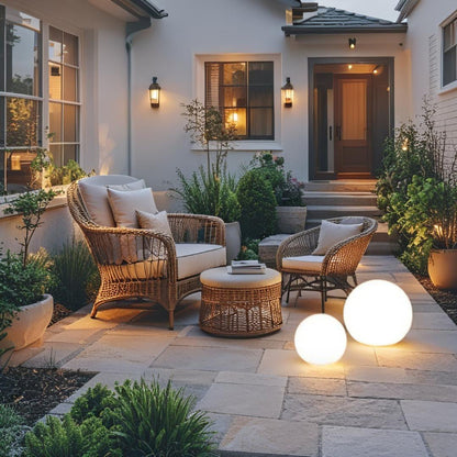 LED garden ball lights on stone patio in warm evening setting
