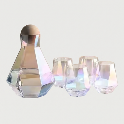 Set of iridescent glassware including a carafe and four glasses on a light gray background