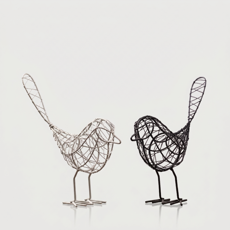 Two iron bird sculptures on white background