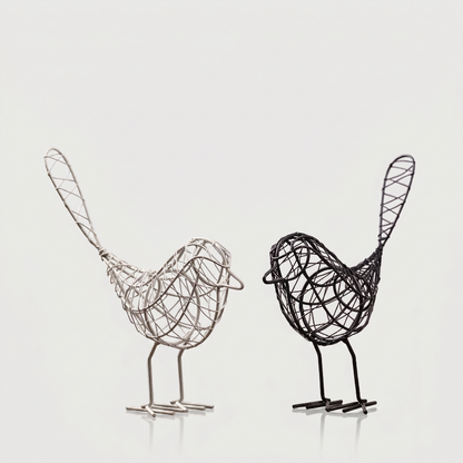 Two iron bird sculptures on white background