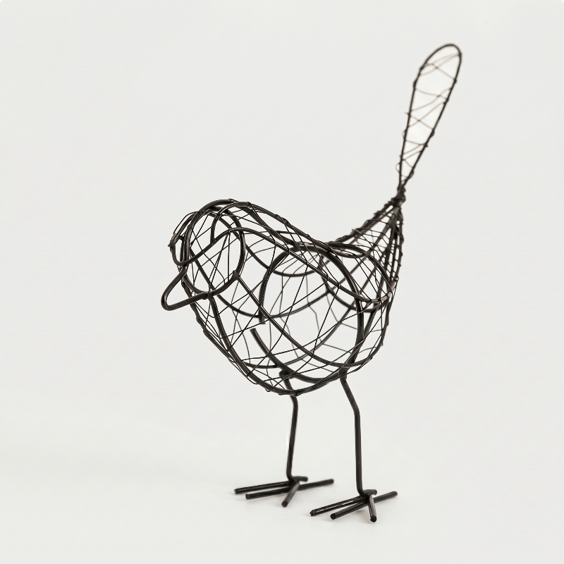 Iron bird sculpture on white background facing right