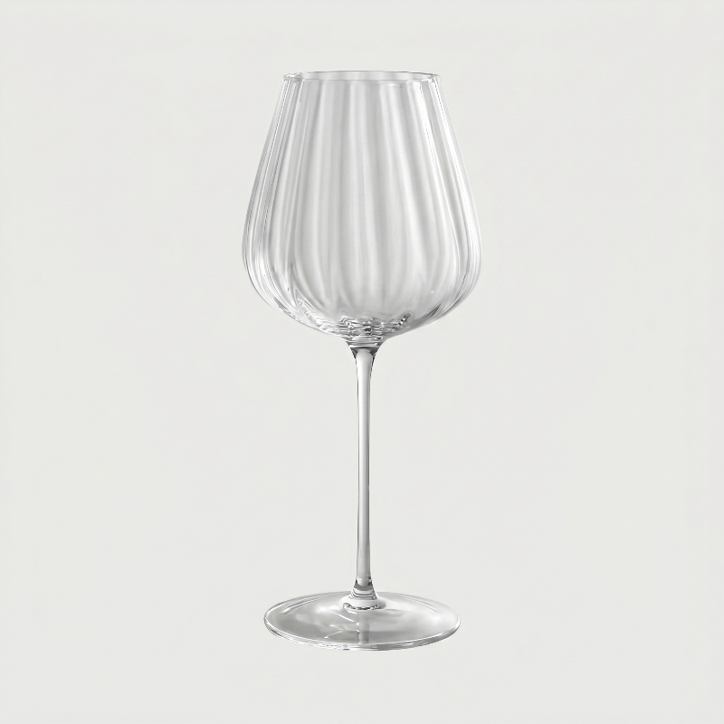 Clear wine glass on a light gray background