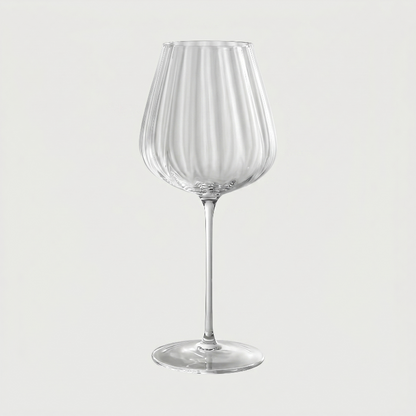 Clear wine glass on a light gray background
