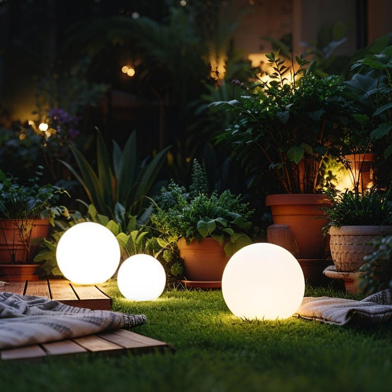 LED garden ball lights glowing in landscaped garden at night