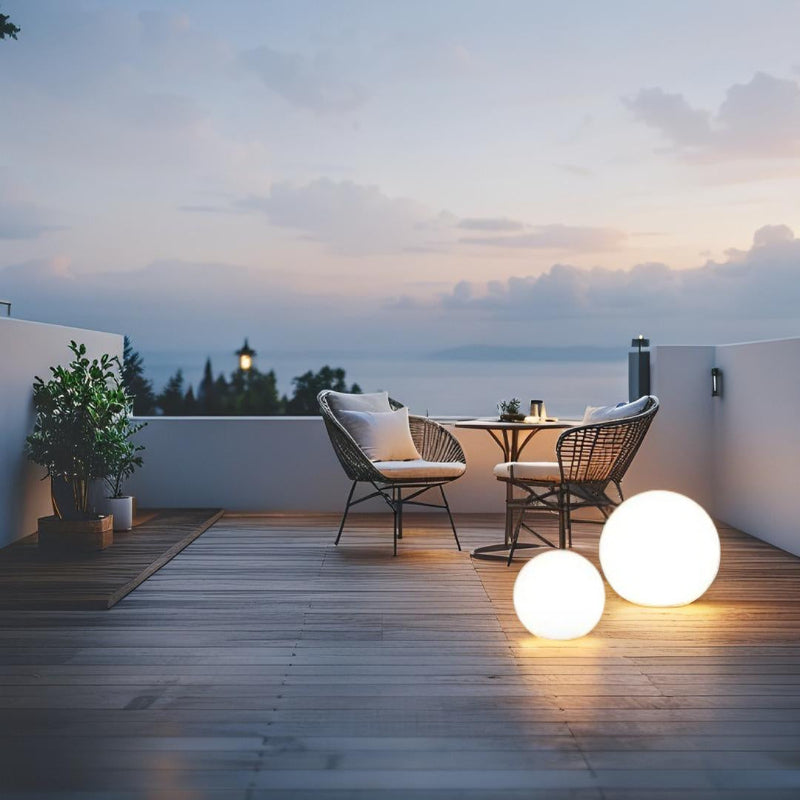 LED garden ball lights on terrace overlooking ocean at dusk
