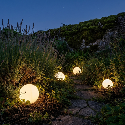 LED garden ball lights glowing along garden path at dusk