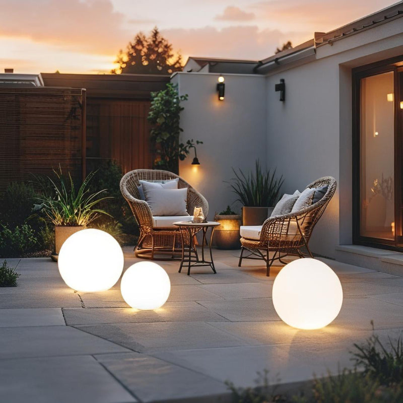 LED garden ball lights on patio dining area at sunset