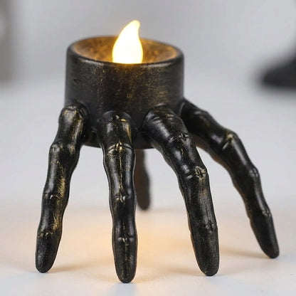Close-up of the lit Hand LED Halloween candle showing its skeletal finger detail
