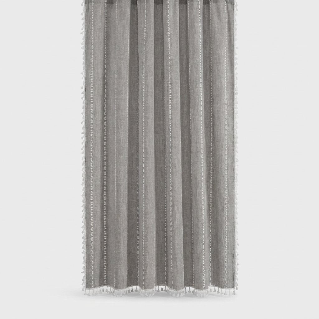 Medium gray linen shower curtain with thin white stitched vertical stripes and white tassels on a light grey background