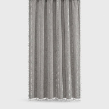 Medium gray linen shower curtain with thin white stitched vertical stripes and white tassels on a light grey background