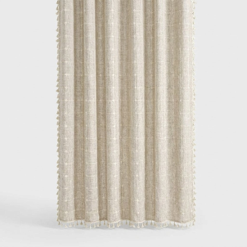 Light oatmeal windowpane linen shower curtain with a faint cream grid and cream tassels along the hem and sides on a light grey background