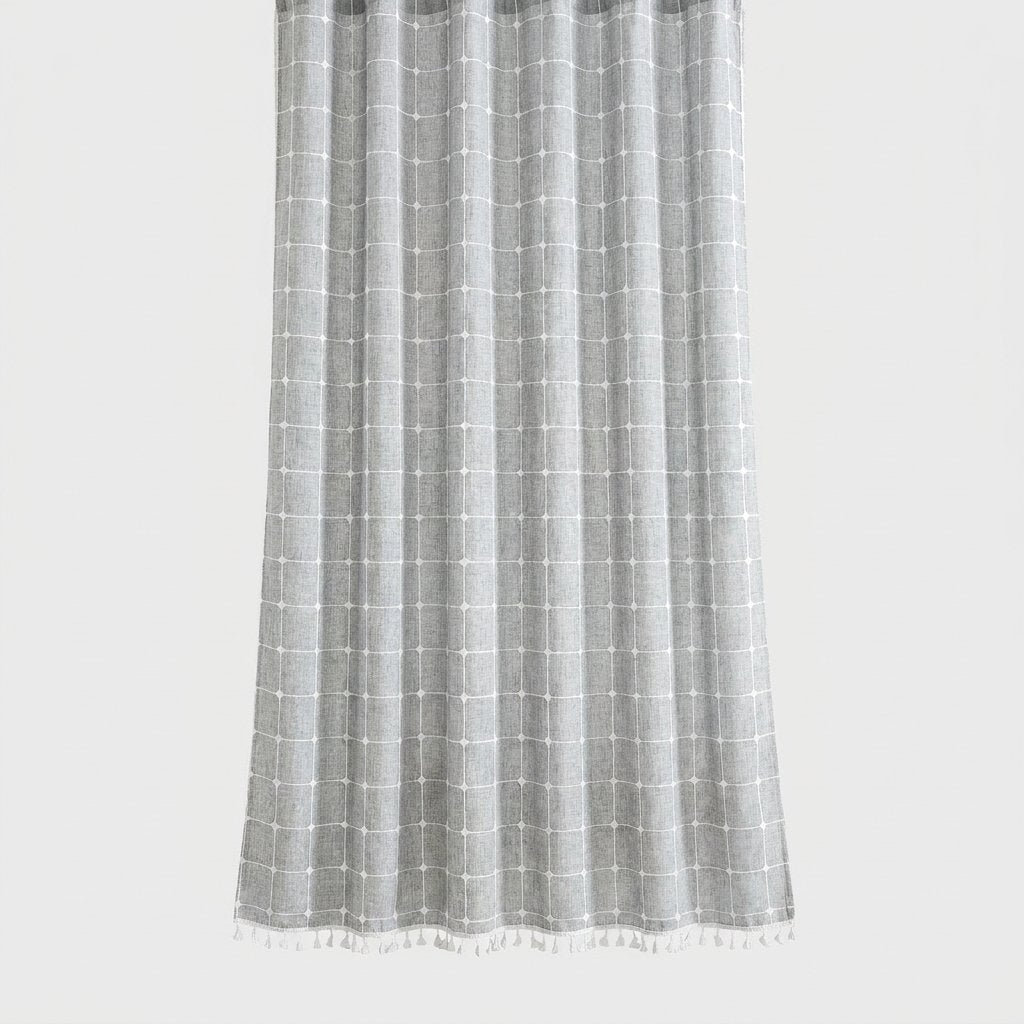 Heathered light gray windowpane linen shower curtain with a white grid and small white tassel hem on a light grey background