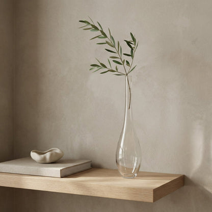 Lucia hand-blown clear glass vase with olive stem on wooden shelf