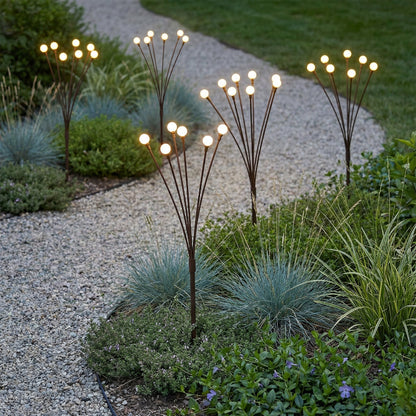 Decorative garden lights in a garden setting with plants and gravel.