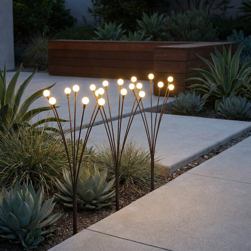 Glowing outdoor garden lights among succulents at night