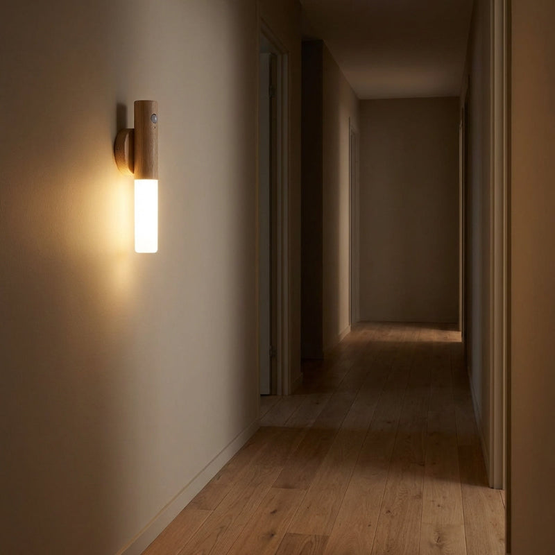 Wall-mounted light fixture casting a warm glow in a dimly lit hallway.