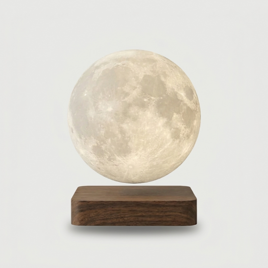 Luna floating moon lamp on dark wood base on white background