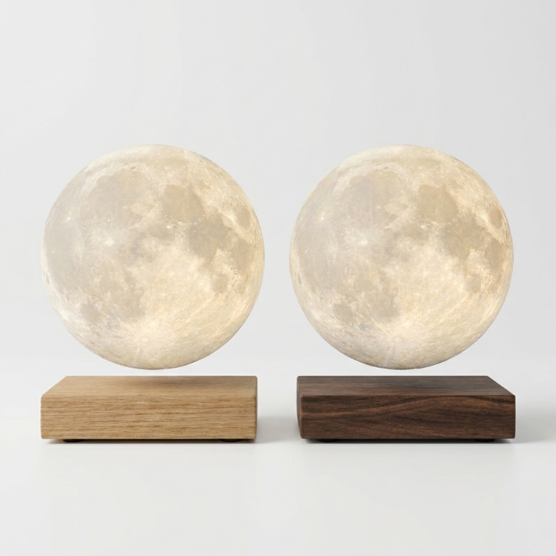 Luna floating moon lamp shown on dark and light wood bases
