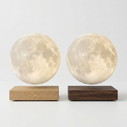 Luna floating moon lamp shown on dark and light wood bases