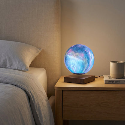 Colorful levitating globe lamp on a bedside table next to a bed
