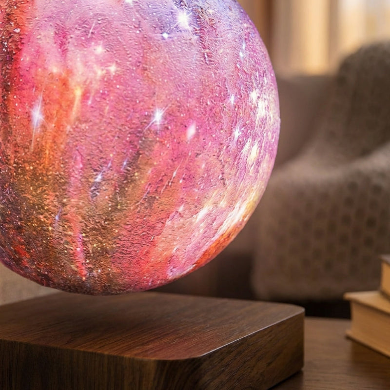 Colorful nebula-shaped lamp on a wooden base in a cozy room setting.