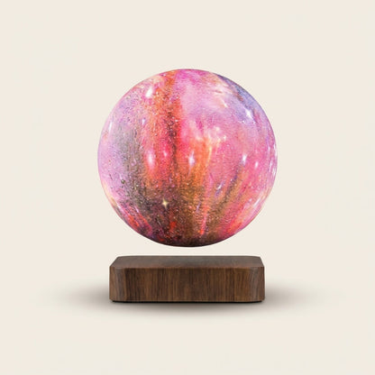 Pink moon lamp on a wooden base against a beige background